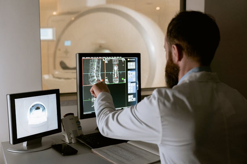 Doctor examining medical imaging data on computer monitor